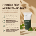 Anua Heartleaf Sonnencreme LSF 50+ vor beigem Hintergrund mit Herzblatt-Zweigen, daneben vier Produktvorteile